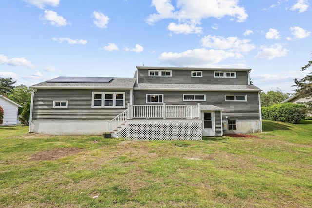 33 Jolley Rd, Plainfield, CT 06239 - rear view of house with a lawn, solar panels, a deck, roof with shingles, and stairway