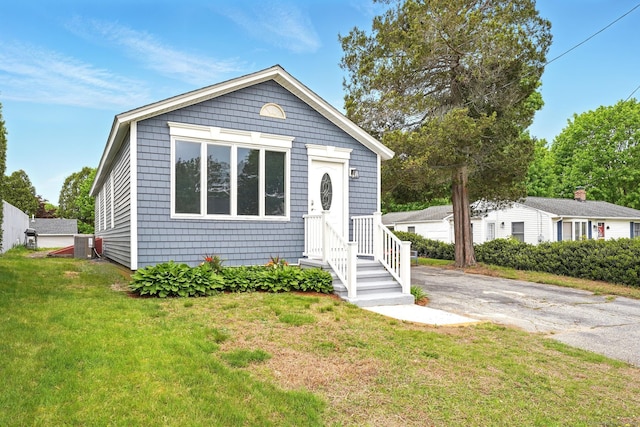 27 Prospect Ave, East Lyme, CT 06357 - view of front of home with a front yard, central AC unit, and asphalt driveway