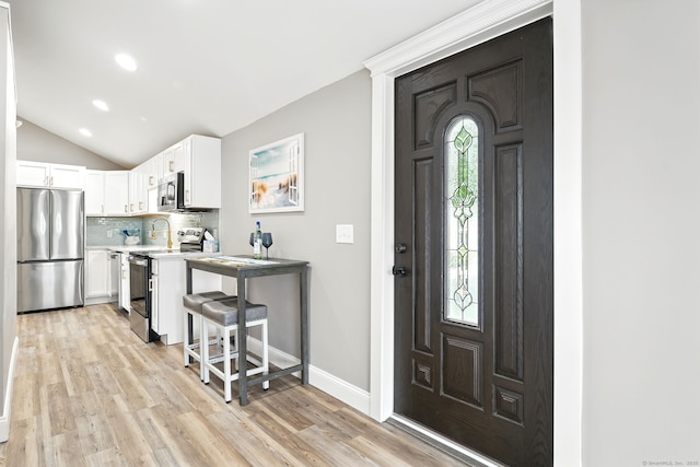 27 Prospect Ave, East Lyme, CT 06357 - foyer entrance with light wood-type flooring, vaulted ceiling, baseboards, and recessed lighting
