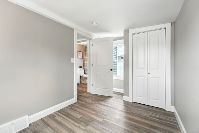 27 Prospect Ave, East Lyme, CT 06357 - unfurnished bedroom with wood finished floors, baseboards, and a closet