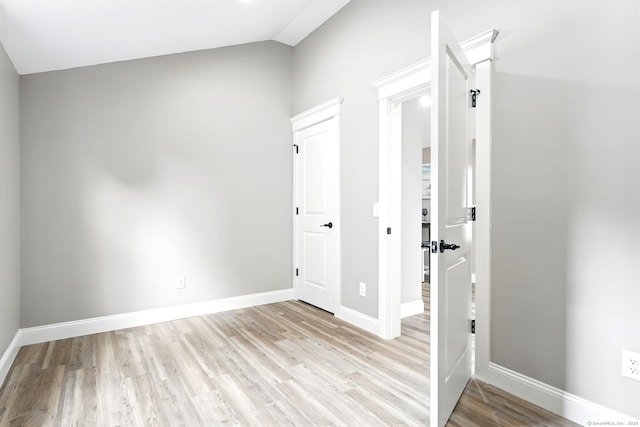 27 Prospect Ave, East Lyme, CT 06357 - unfurnished bedroom with light wood-style floors, lofted ceiling, and baseboards