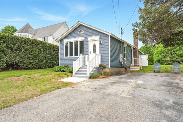 27 Prospect Ave, East Lyme, CT 06357 - view of front of house with a front lawn and a chimney