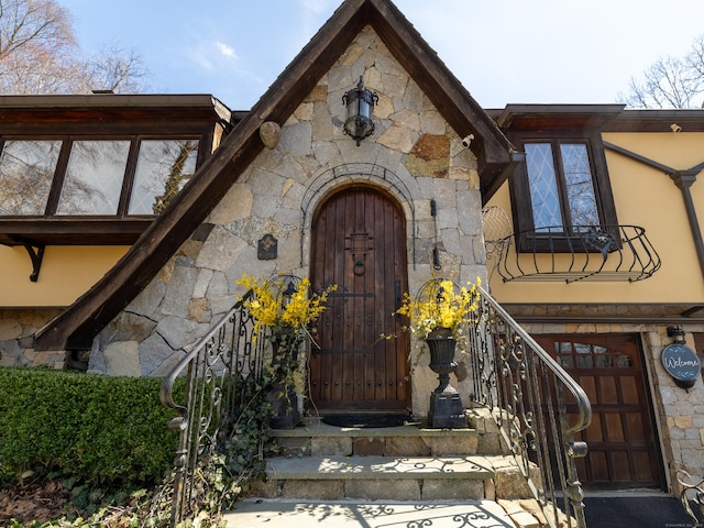 entrance to property featuring stone siding