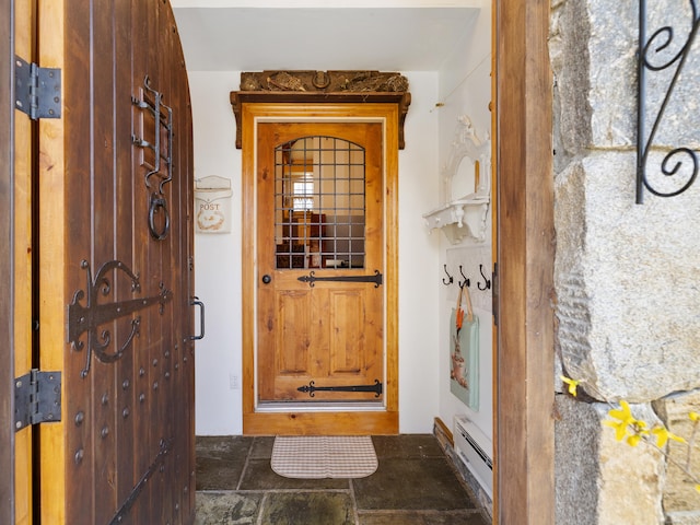 property entrance with a baseboard radiator