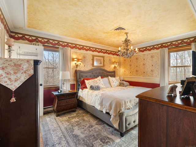 bedroom with baseboard heating, an inviting chandelier, ornamental molding, and visible vents