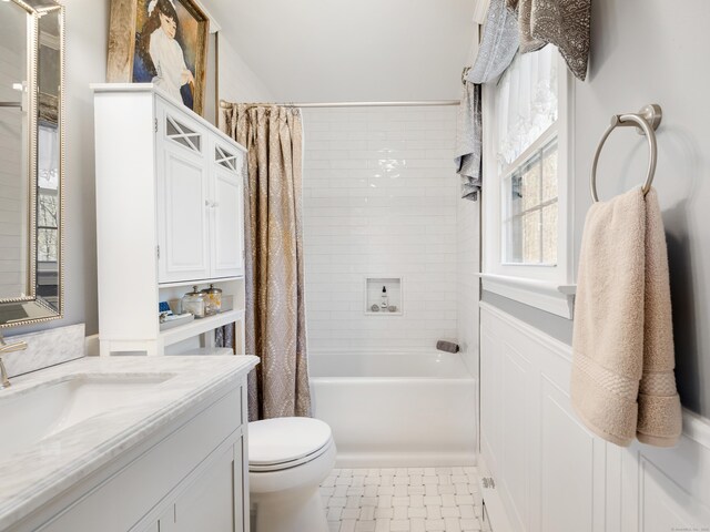 bathroom featuring shower / tub combo, toilet, and vanity