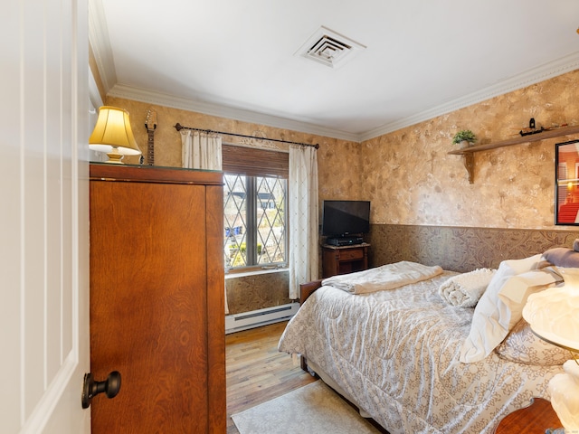 bedroom featuring wallpapered walls, wood finished floors, visible vents, a baseboard heating unit, and crown molding