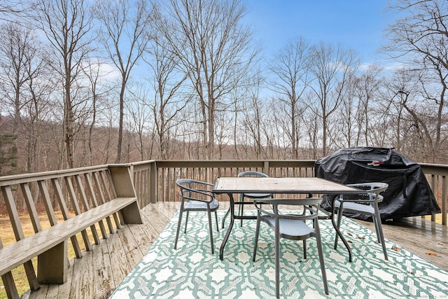 wooden deck featuring outdoor dining area and grilling area