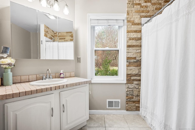 full bathroom with curtained shower, tile patterned flooring, visible vents, vanity, and baseboards