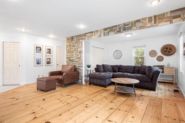 living room with recessed lighting, visible vents, and light wood-style flooring