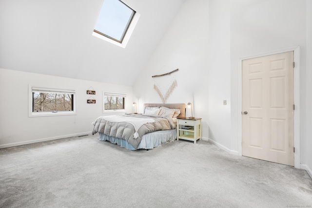 bedroom with high vaulted ceiling, baseboards, a skylight, and carpet