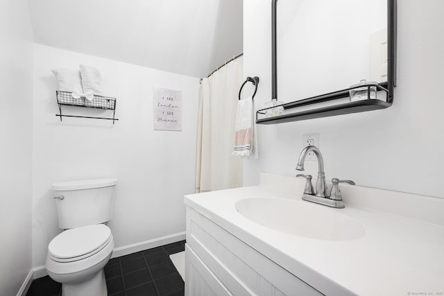 bathroom with vanity, toilet, tile patterned flooring, and baseboards