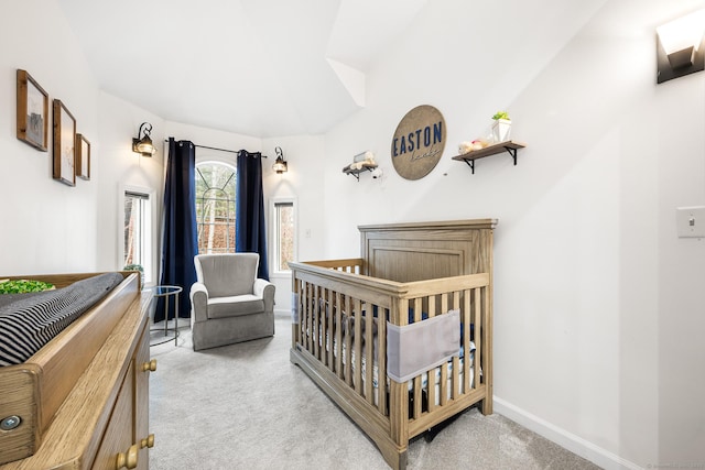 bedroom featuring vaulted ceiling, carpet, a crib, and baseboards