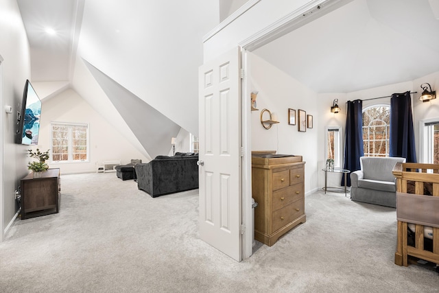 bedroom featuring light carpet, lofted ceiling, and baseboards