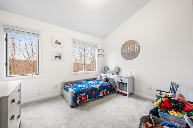 bedroom with baseboards, lofted ceiling, and carpet