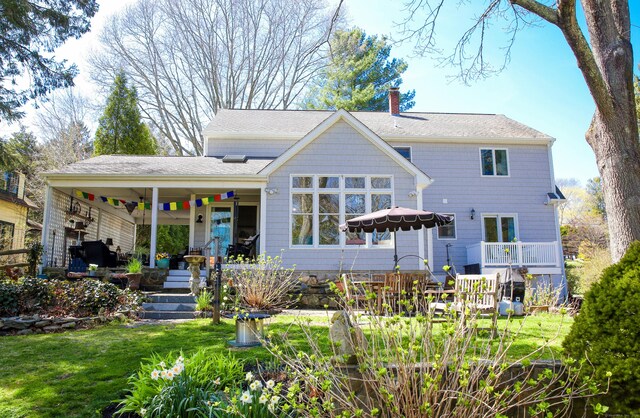 6 Rogers Dr, Stonington, CT 06355 - rear view of property featuring a chimney, a yard, a porch, and ceiling fan