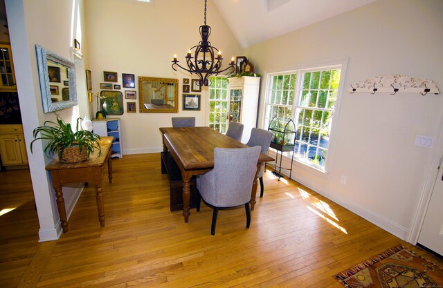 6 Rogers Dr, Stonington, CT 06355 - dining space with high vaulted ceiling, a chandelier, light wood-type flooring, and baseboards