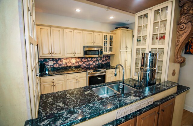 6 Rogers Dr, Stonington, CT 06355 - kitchen featuring stainless steel appliances, a sink, glass insert cabinets, tasteful backsplash, and recessed lighting