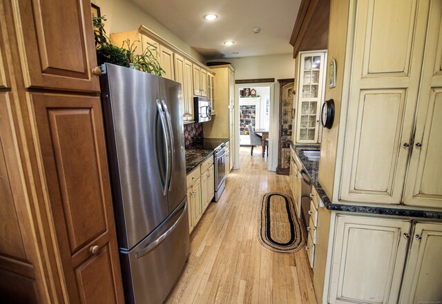 6 Rogers Dr, Stonington, CT 06355 - kitchen with stainless steel appliances, recessed lighting, light wood finished floors, dark stone countertops, and cream cabinets