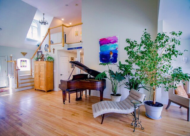 6 Rogers Dr, Stonington, CT 06355 - sitting room featuring stairs, high vaulted ceiling, healthy amount of natural light, light wood-type flooring, and a chandelier