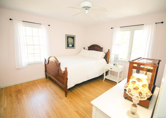 6 Rogers Dr, Stonington, CT 06355 - bedroom with light wood-style flooring, multiple windows, and baseboards