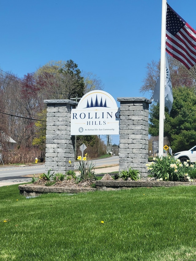 community sign featuring a lawn