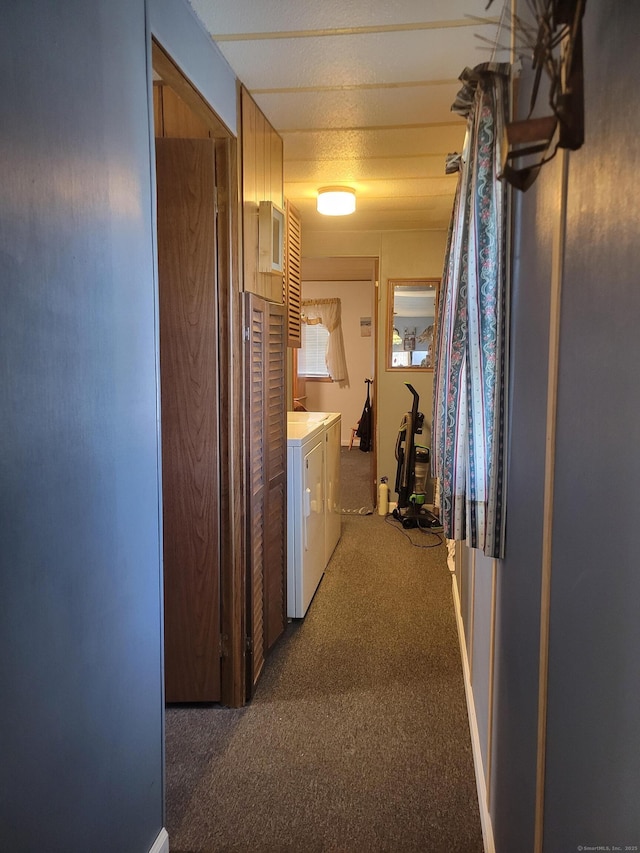 corridor featuring carpet flooring and washer and clothes dryer