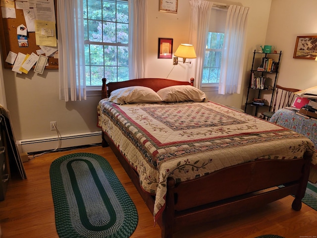 38 Somerset Dr, Manchester, CT 06040 - bedroom featuring a baseboard heating unit and wood finished floors