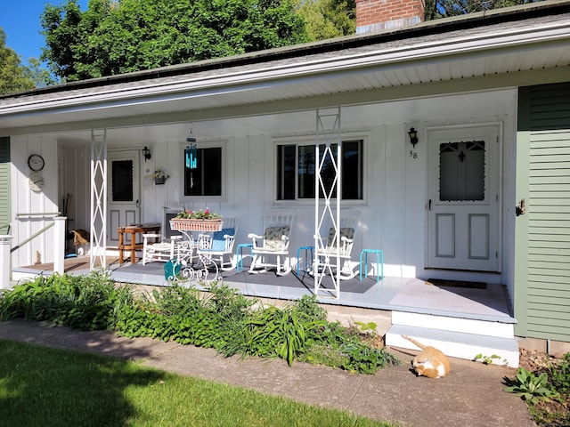 38 Somerset Dr, Manchester, CT 06040 - exterior space with covered porch, a chimney, and board and batten siding