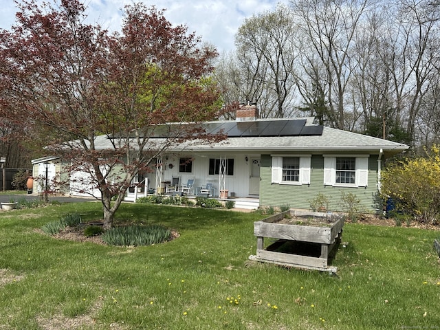 38 Somerset Dr, Manchester, CT 06040 - rear view of house with roof mounted solar panels, a chimney, a yard, and covered porch