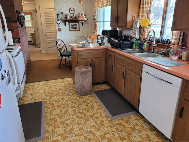 38 Somerset Dr, Manchester, CT 06040 - kitchen with dishwasher, a sink, stove, a peninsula, and light countertops
