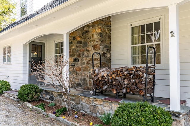 entrance to property featuring stone siding and covered porch