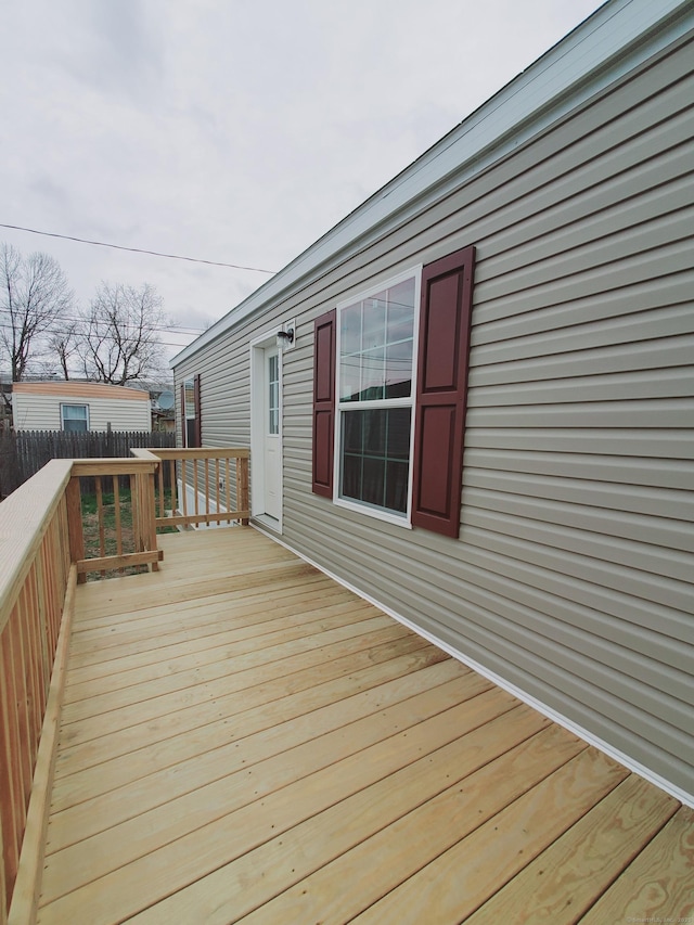 wooden terrace featuring fence