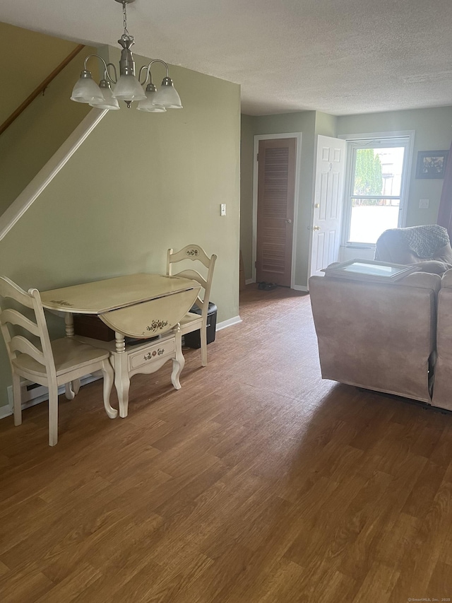 51 Mortimer St Apt 9, Torrington, CT 06790 - dining room with baseboards, wood finished floors, an inviting chandelier, and a textured ceiling