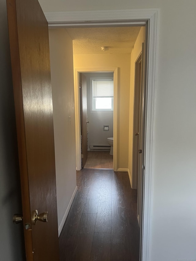 51 Mortimer St Apt 9, Torrington, CT 06790 - hallway featuring baseboards, baseboard heating, and dark wood-style floors