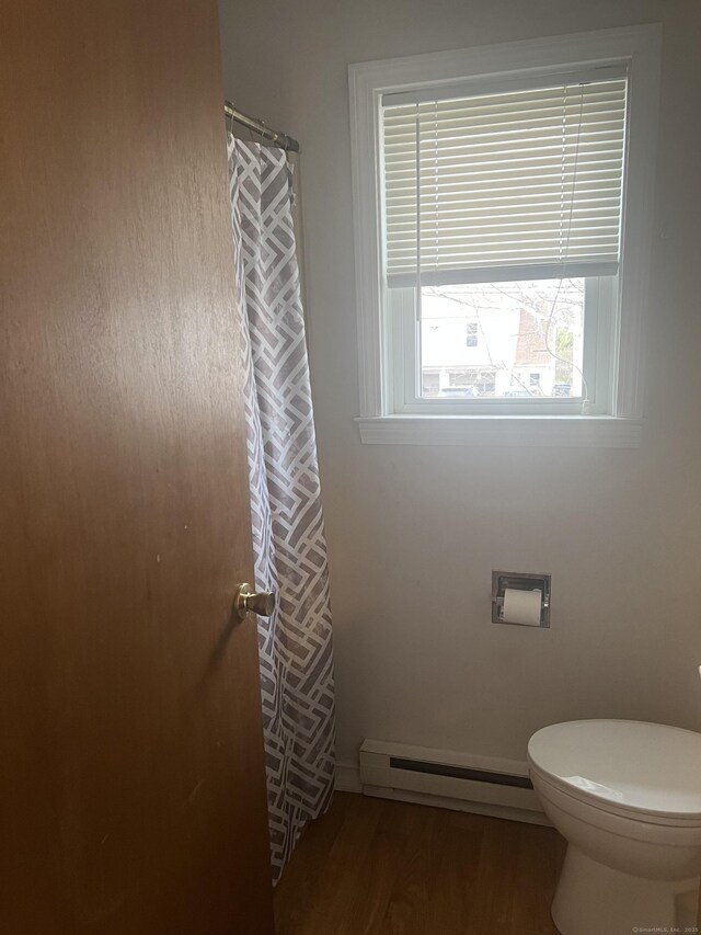 51 Mortimer St Apt 9, Torrington, CT 06790 - full bathroom with a baseboard radiator, wood finished floors, toilet, and a shower with curtain