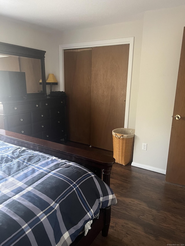 51 Mortimer St Apt 9, Torrington, CT 06790 - bedroom featuring baseboards, wood finished floors, and a closet