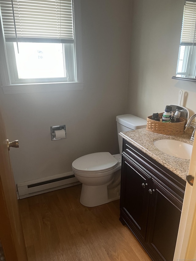 51 Mortimer St Apt 9, Torrington, CT 06790 - bathroom with a baseboard heating unit, wood finished floors, vanity, and toilet