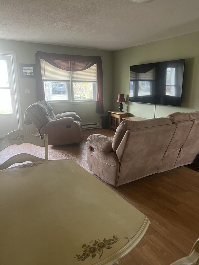 51 Mortimer St Apt 9, Torrington, CT 06790 - living room featuring a baseboard heating unit, wood finished floors, and a textured ceiling