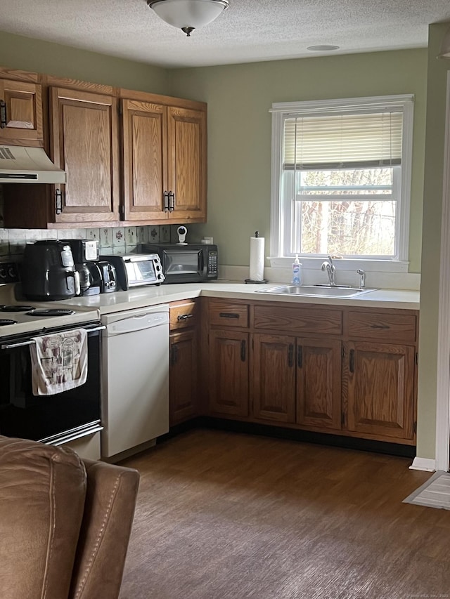 51 Mortimer St Apt 9, Torrington, CT 06790 - kitchen with brown cabinets, light countertops, a sink, white dishwasher, and electric range