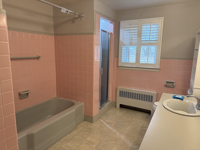 278 Dudley Town Rd, Windsor, CT 06095 - full bathroom with radiator heating unit, tile walls, a shower with shower door, a bath, and vanity