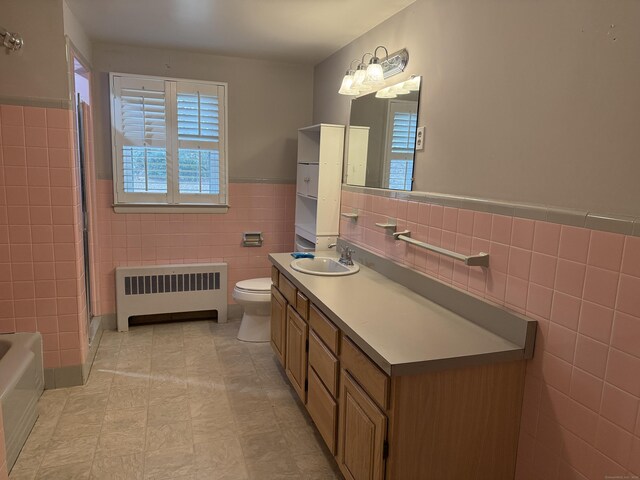 278 Dudley Town Rd, Windsor, CT 06095 - full bathroom featuring radiator, tile walls, toilet, a wainscoted wall, and vanity