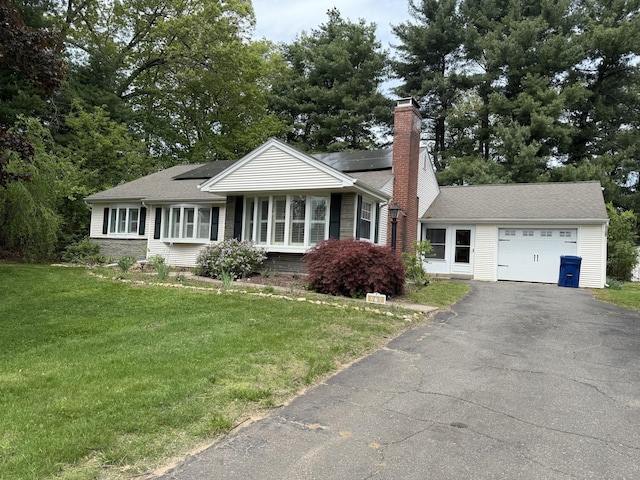 278 Dudley Town Rd, Windsor, CT 06095 - ranch-style house with a garage, a chimney, driveway, a front lawn, and solar panels