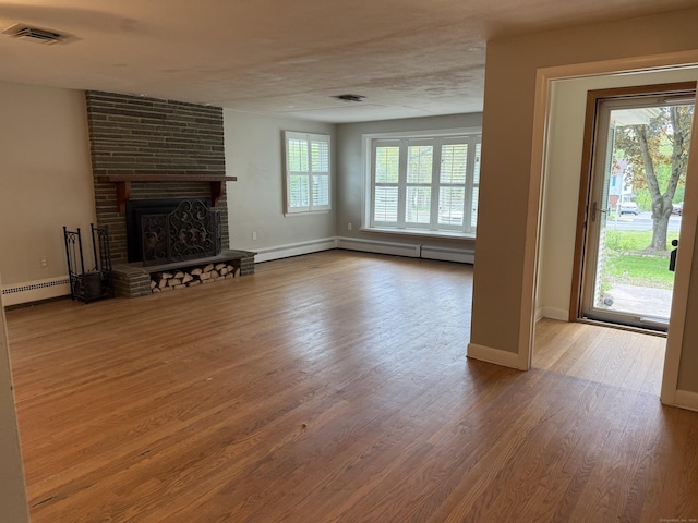 278 Dudley Town Rd, Windsor, CT 06095 - unfurnished living room with baseboard heating, wood finished floors, baseboards, and a fireplace
