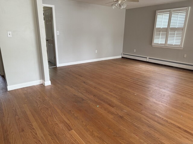 278 Dudley Town Rd, Windsor, CT 06095 - unfurnished room featuring a baseboard heating unit, dark wood finished floors, a ceiling fan, and baseboards