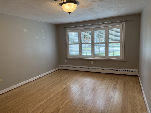 278 Dudley Town Rd, Windsor, CT 06095 - spare room featuring baseboard heating, wood finished floors, and baseboards