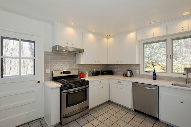 45 Wayside Ln, Redding, CT 06896 - kitchen featuring appliances with stainless steel finishes, under cabinet range hood, a sink, light countertops, and decorative backsplash