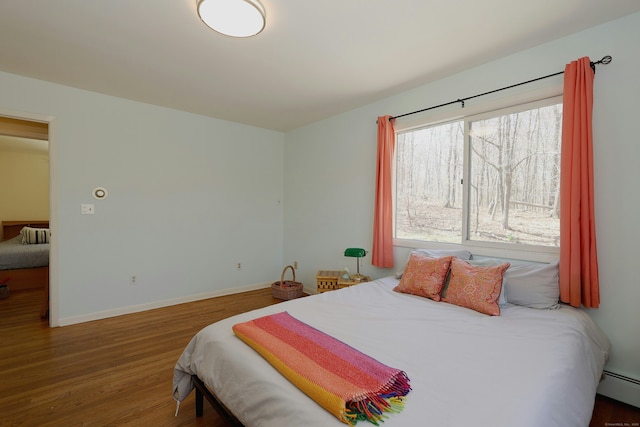45 Wayside Ln, Redding, CT 06896 - bedroom with wood finished floors, baseboards, and a baseboard heating unit