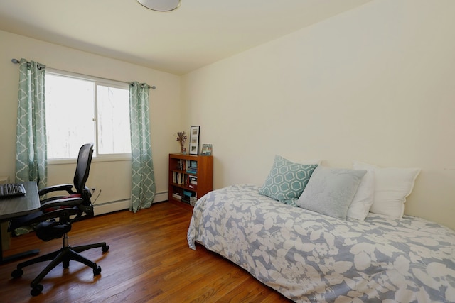 45 Wayside Ln, Redding, CT 06896 - bedroom with wood finished floors, an office area, baseboard heating, and a baseboard heating unit