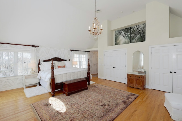 37 Giles Hill Rd, Redding, CT 06896 - bedroom with an inviting chandelier, visible vents, a towering ceiling, wallpapered walls, and light wood-style flooring